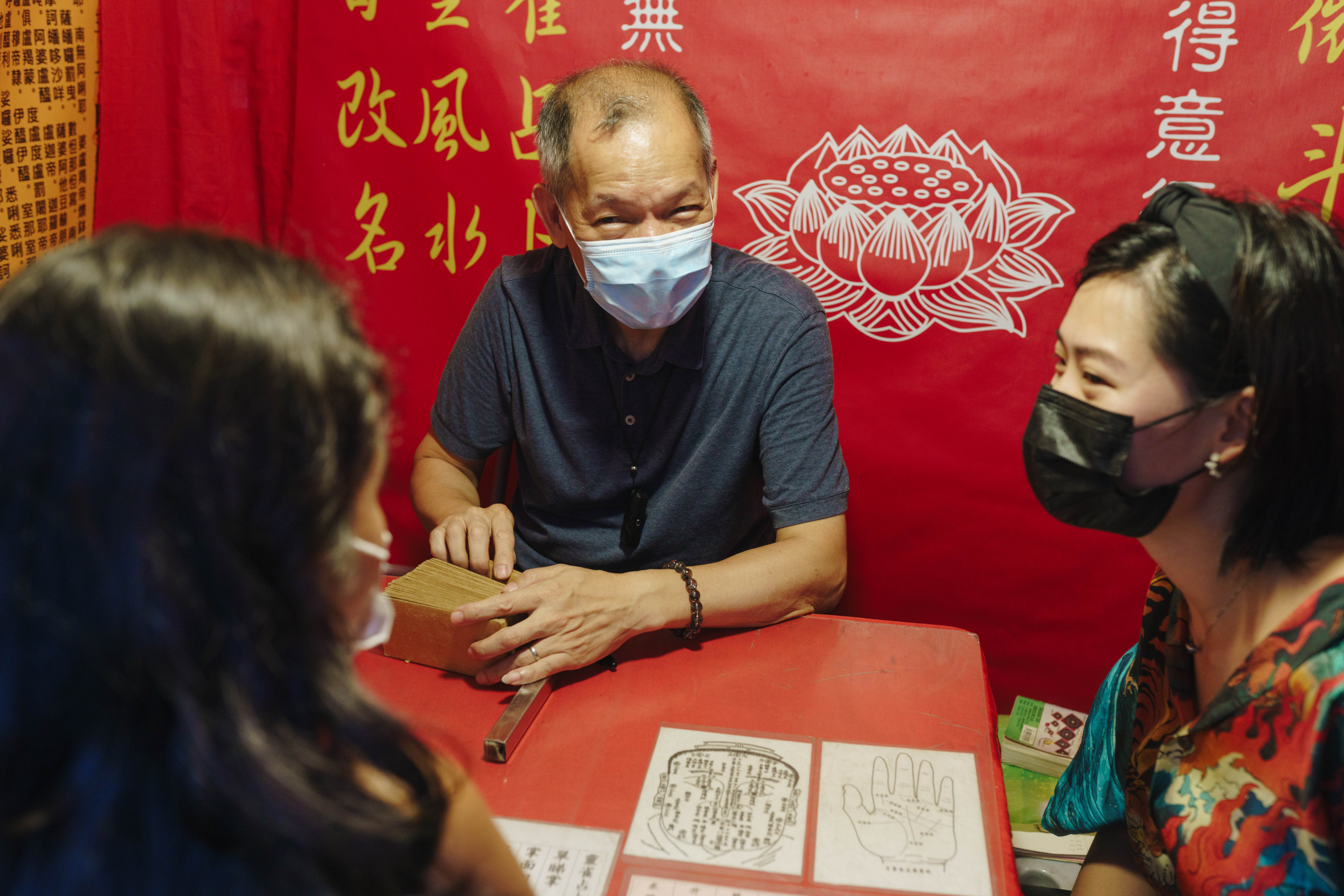 Experience the unique charm of Hong Kong as a seasoned fortune teller shares insights while you explore the intriguing blend of culture and community at Temple Street.